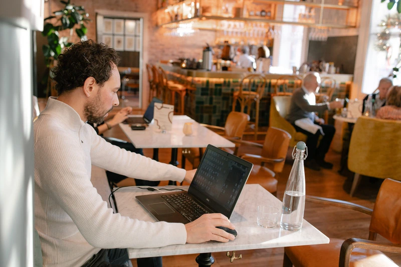 House21 co-working lounge with members working in a warm, design-led space in Oslo