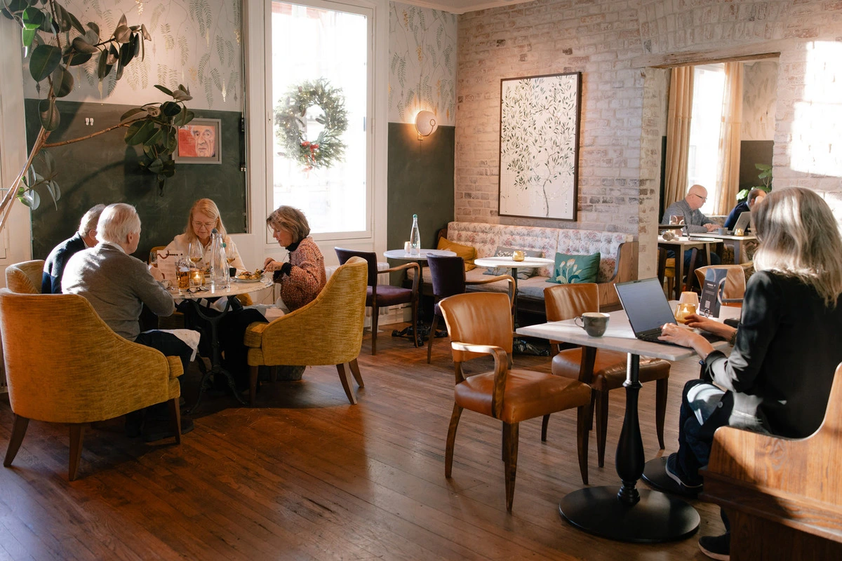 House21 co-working lounge with natural light and members working